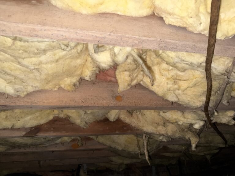 Sagging fiberglass insulation between crawlspace floor joists